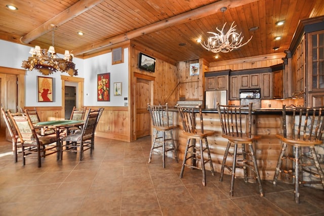 686 Lake Dr N, Morganton, GA 30560 - kitchen with a chandelier, stainless steel fridge, black microwave, wood ceiling with exposed beams, and dark countertops