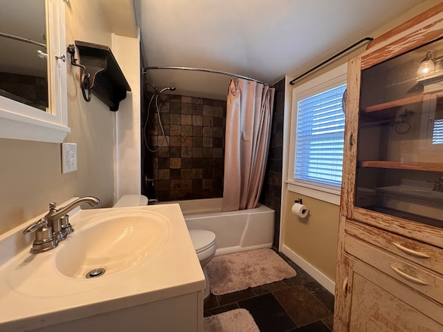 bathroom featuring shower / tub combo, vanity, toilet, and baseboards