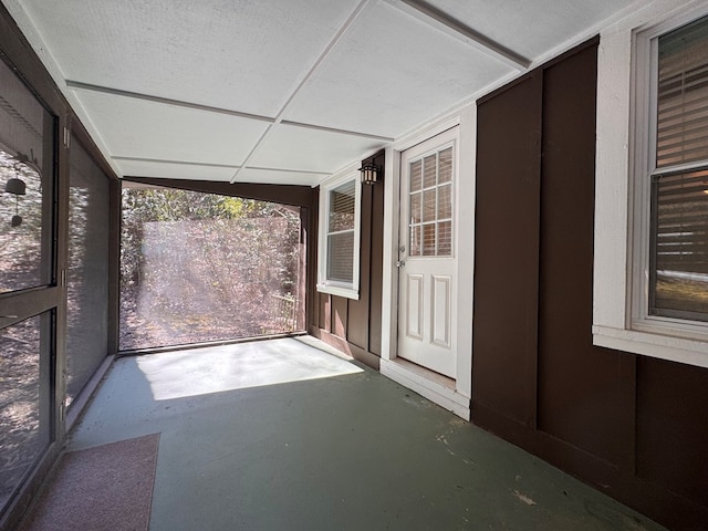 unfurnished sunroom featuring a drop ceiling