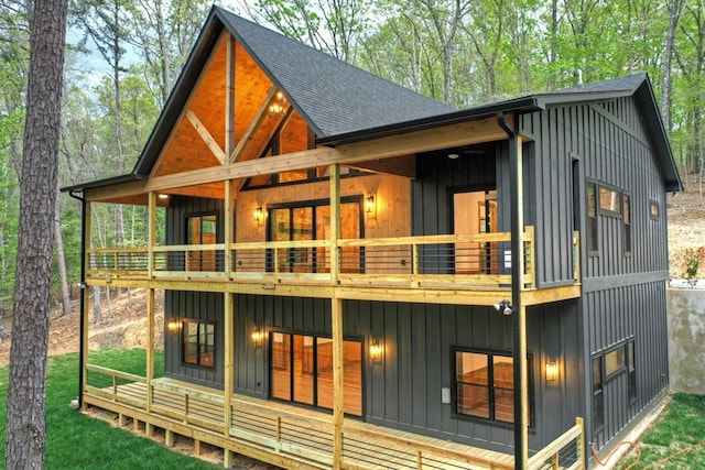 84 Grant Ln, Mineral Bluff, GA 30559 - rear view of house featuring roof with shingles, a balcony, and board and batten siding