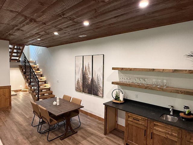84 Grant Ln, Mineral Bluff, GA 30559 - dining area featuring bar with sink, stairway, dark wood finished floors, baseboards, and recessed lighting