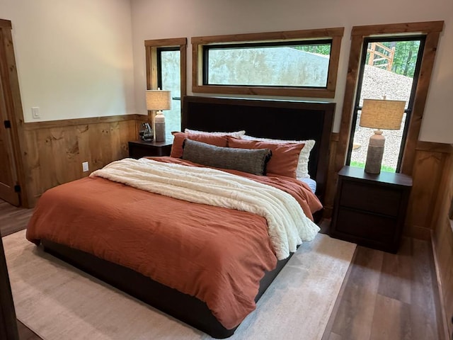 84 Grant Ln, Mineral Bluff, GA 30559 - bedroom featuring wood finished floors, wainscoting, and wood walls