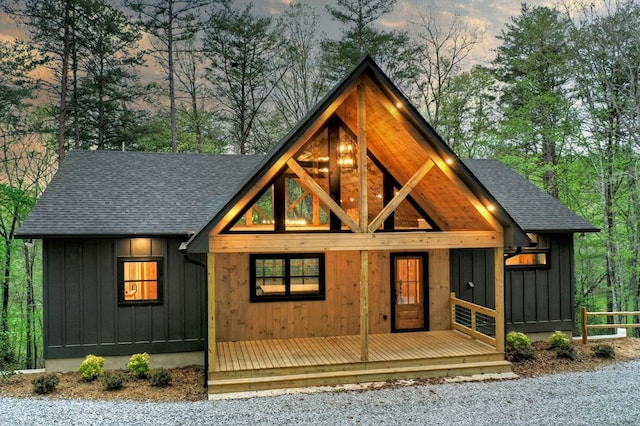 84 Grant Ln, Mineral Bluff, GA 30559 - view of front of house featuring a shingled roof, board and batten siding, and view of scattered trees