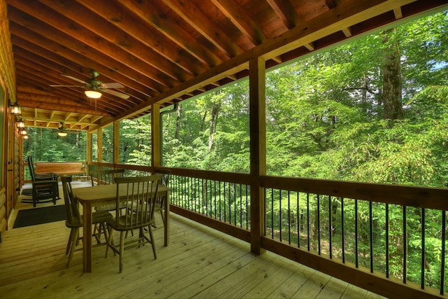 4527 Gates Chapel Rd, Ellijay, GA 30540 - wooden deck with outdoor dining space, ceiling fan, and a wooded view