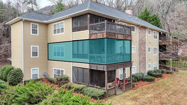 rear view of house featuring a patio and a sunroom