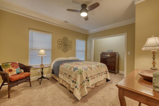 carpeted bedroom with ceiling fan, crown molding, and a textured ceiling