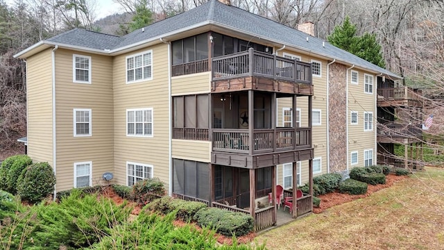 rear view of house featuring a patio and a sunroom