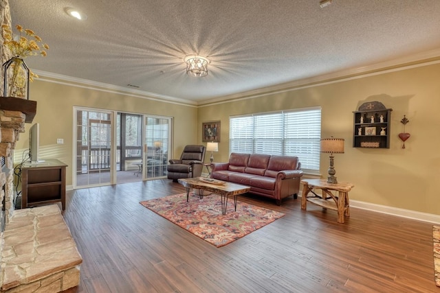 living room featuring hardwood / wood-style flooring, ornamental molding, and a textured ceiling