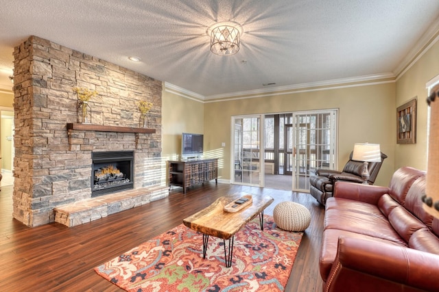 living room with a fireplace, a textured ceiling, hardwood / wood-style flooring, and crown molding