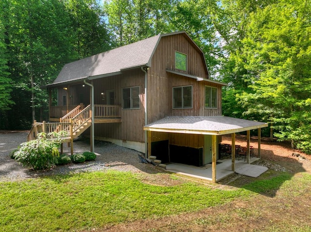 4525 Gates Chapel Rd, Ellijay, GA 30540 - rear view of house featuring a shingled roof, stairs, a lawn, a gambrel roof, and a patio