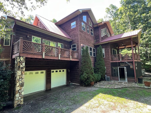 rear view of house featuring a garage