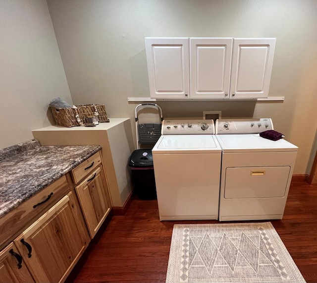 washroom featuring cabinets, dark hardwood / wood-style flooring, and washer and dryer