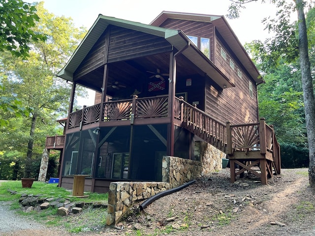 view of home's exterior featuring ceiling fan and a wooden deck