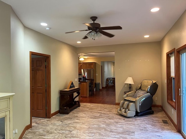 living area with ceiling fan