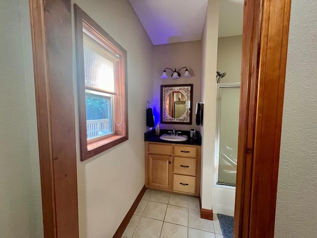 bathroom featuring shower / bath combination with glass door, vanity, and tile patterned floors