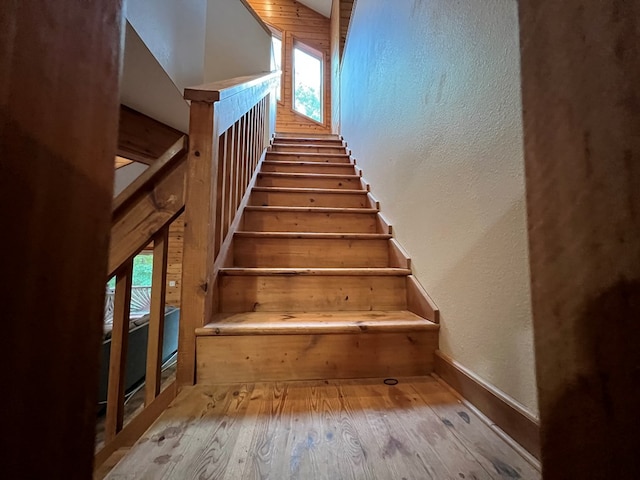 stairs featuring wood-type flooring