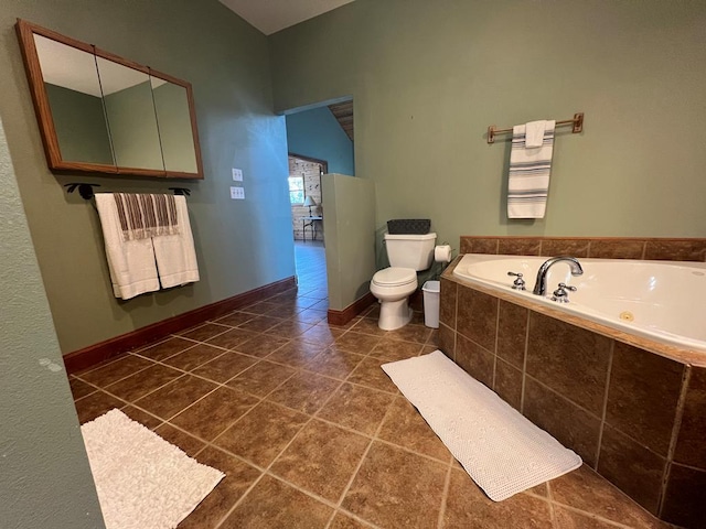 bathroom with tiled tub, radiator heating unit, tile patterned flooring, and toilet