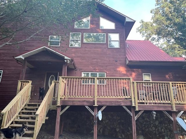 rear view of property featuring a deck