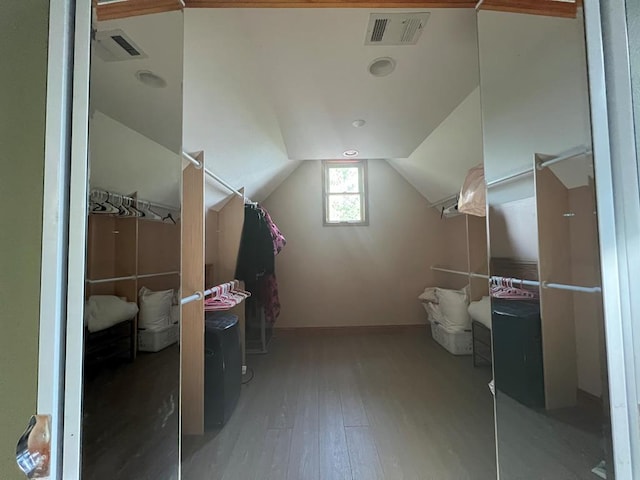 additional living space featuring hardwood / wood-style floors and lofted ceiling