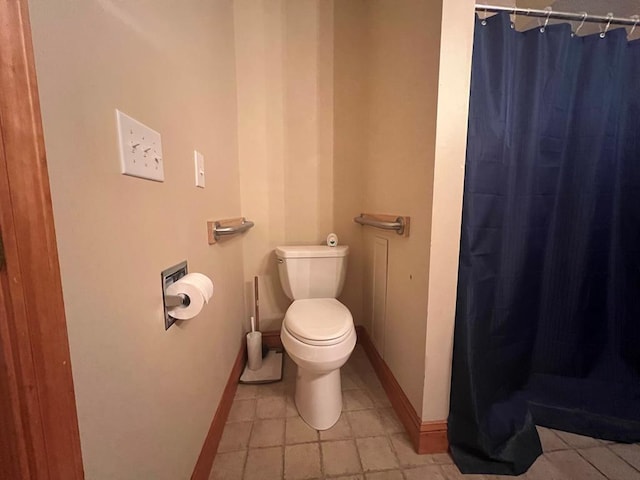 bathroom with tile patterned floors, toilet, and walk in shower