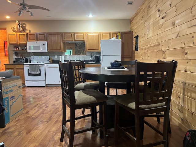 kitchen featuring decorative backsplash, ceiling fan, hardwood / wood-style floors, and white appliances