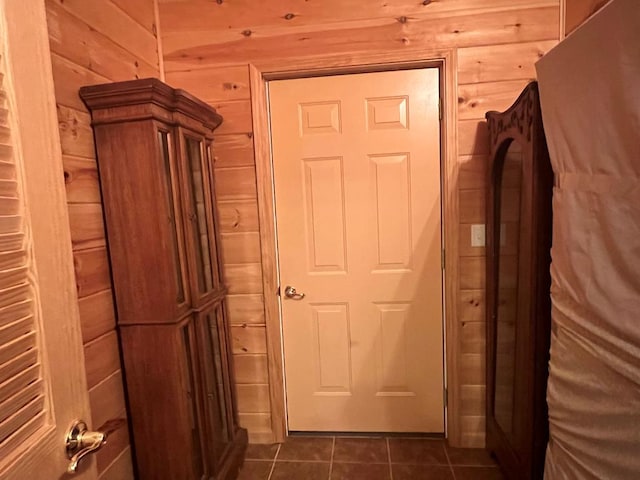 interior space featuring tile patterned floors and wood walls