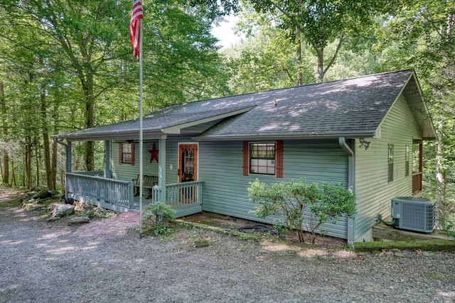 ranch-style house with covered porch and cooling unit