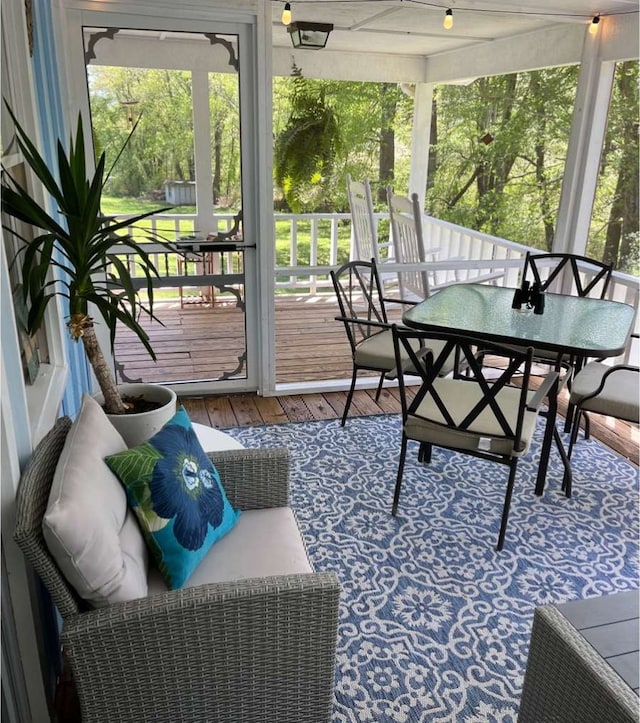 sunroom / solarium featuring a healthy amount of sunlight