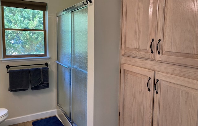 bathroom featuring toilet and walk in shower