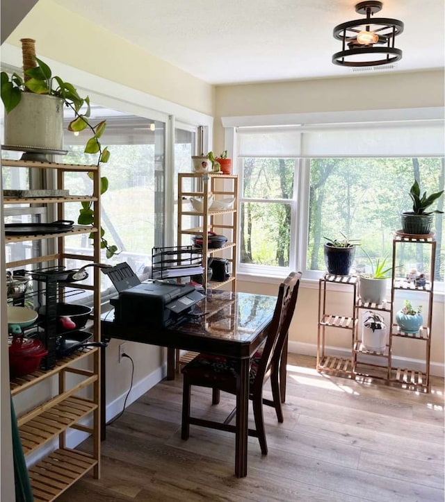 office featuring wood-type flooring and an inviting chandelier