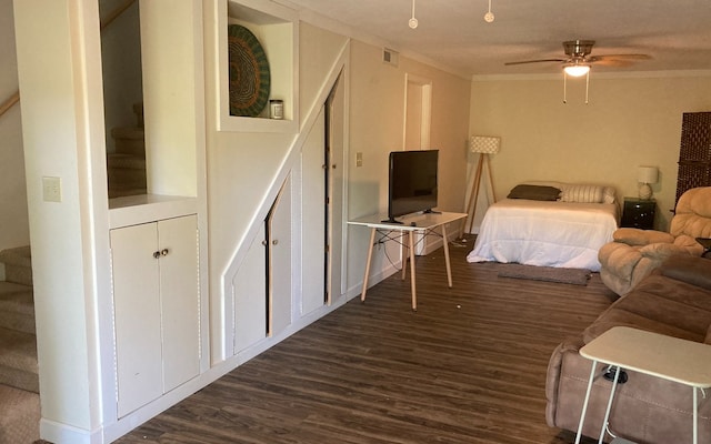 bedroom with ceiling fan, dark hardwood / wood-style flooring, and crown molding