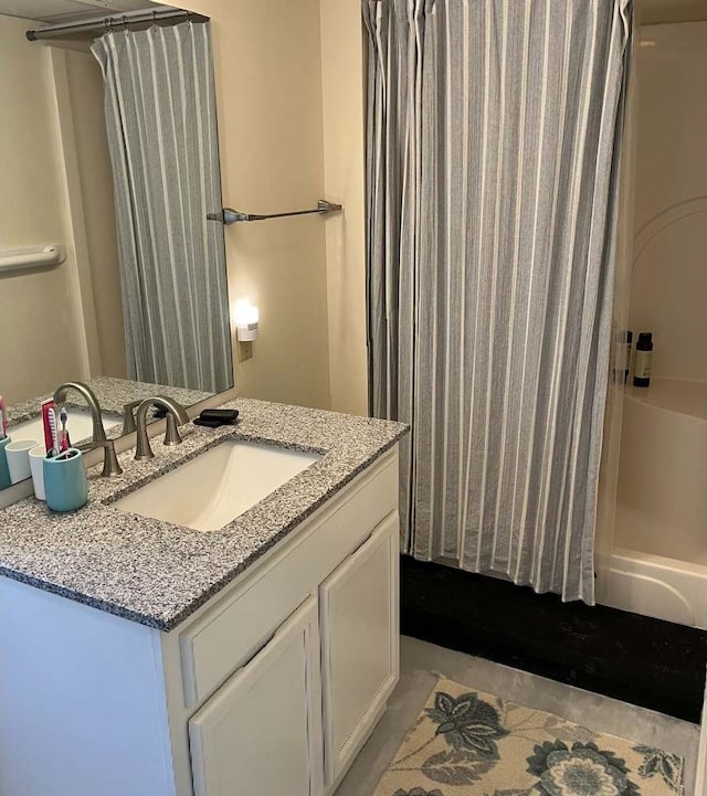 bathroom featuring curtained shower and vanity