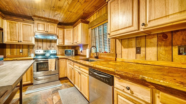 kitchen with appliances with stainless steel finishes, under cabinet range hood, a sink, wooden ceiling, and light brown cabinetry