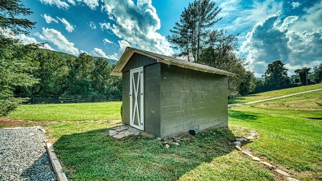 view of shed with fence