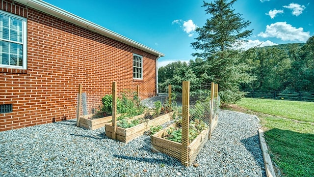 view of yard with fence and a vegetable garden