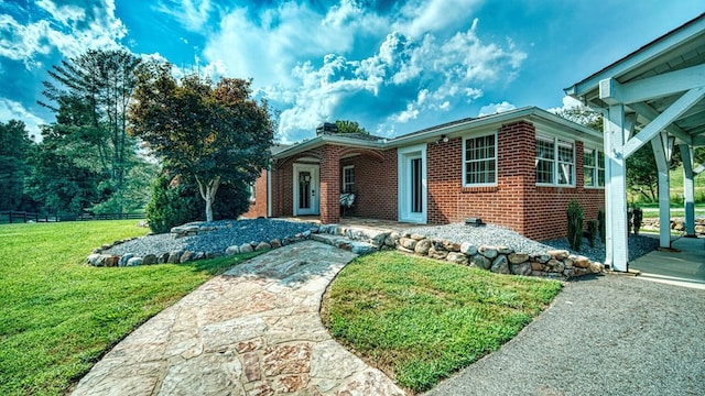 single story home with a front yard and brick siding