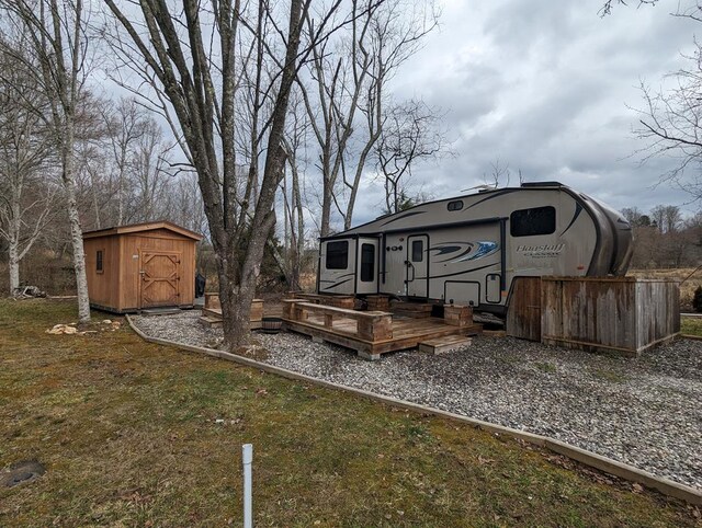 view of yard with a shed and a wooden deck