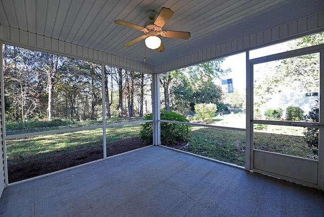 unfurnished sunroom featuring ceiling fan