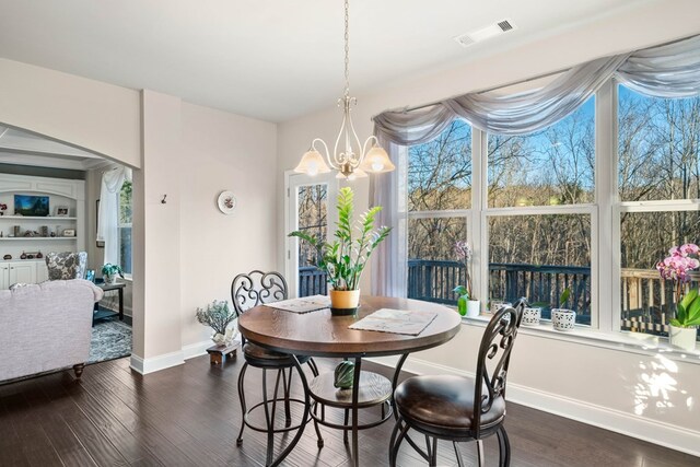 9475 Dunmoore Dr, Cumming, GA 30028 - dining space with dark wood-type flooring, baseboards, visible vents, and a chandelier