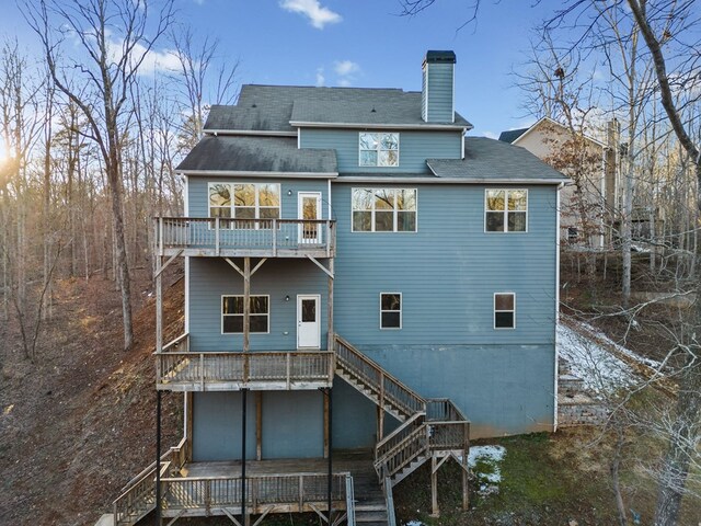 9475 Dunmoore Dr, Cumming, GA 30028 - rear view of property featuring stairs, a wooden deck, and a chimney