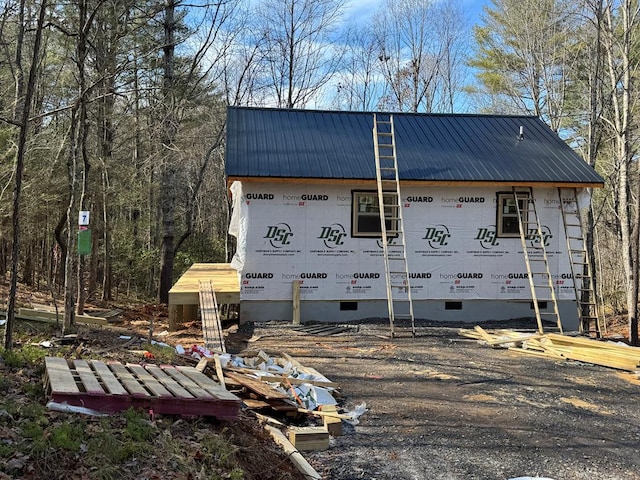 view of property exterior with crawl space and metal roof