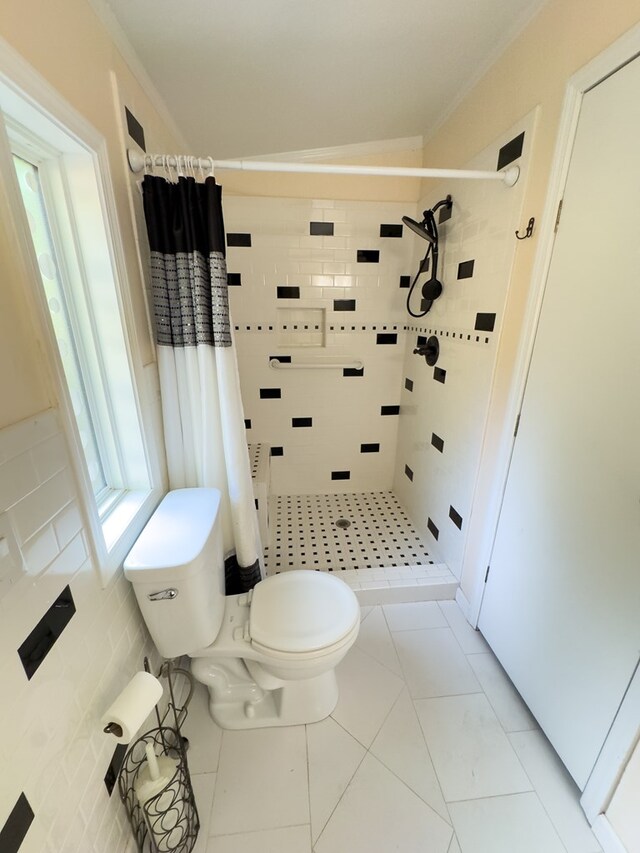 bathroom with toilet, a shower with shower curtain, and tile patterned floors