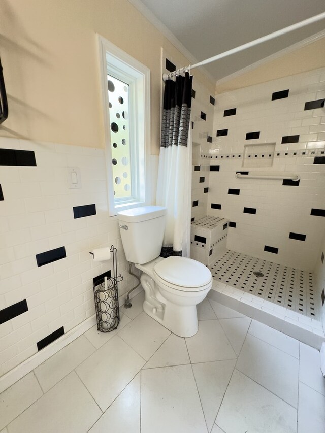 bathroom with tile walls, toilet, tile patterned floors, and walk in shower