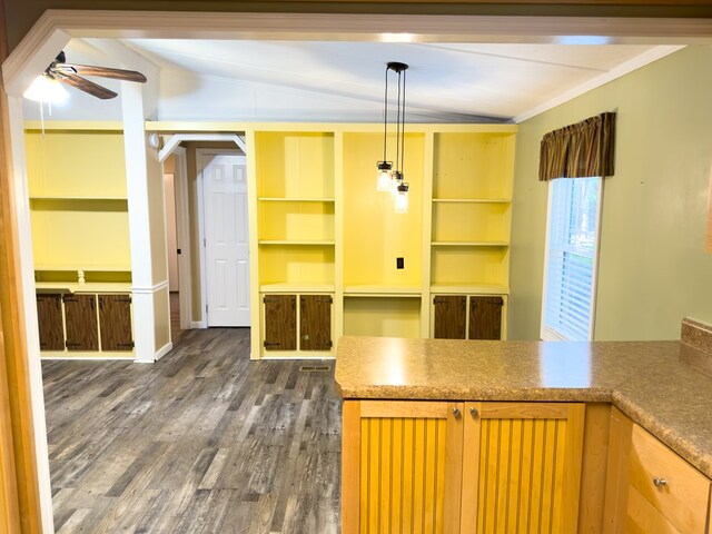 kitchen featuring hanging light fixtures, dark hardwood / wood-style flooring, lofted ceiling, ceiling fan, and ornamental molding