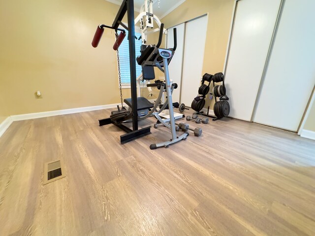 exercise room featuring light wood-type flooring