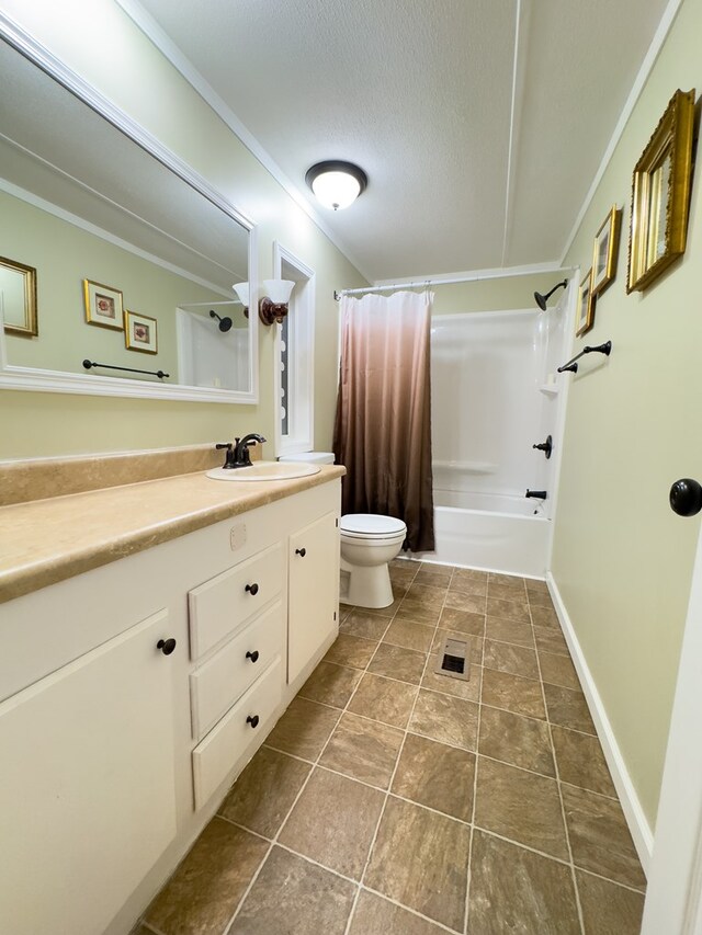 full bathroom featuring toilet, tile patterned floors, vanity, a textured ceiling, and shower / bath combo with shower curtain