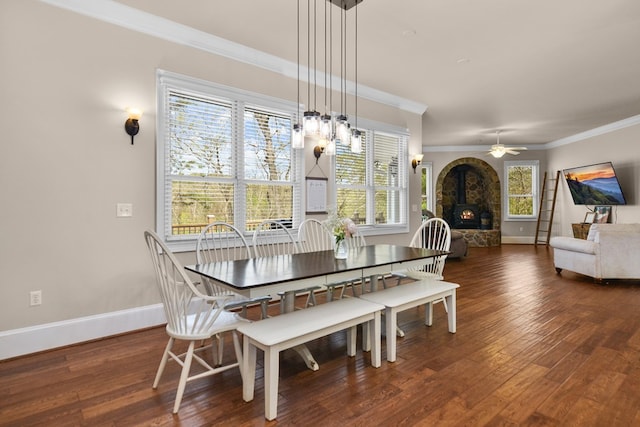 270 Milford Trl, Talking Rock, GA 30175 - dining space featuring crown molding, a wood stove, baseboards, and wood finished floors