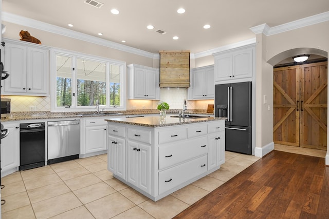 270 Milford Trl, Talking Rock, GA 30175 - kitchen featuring high end black fridge, light stone countertops, visible vents, stainless steel dishwasher, and arched walkways