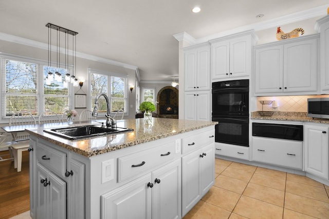270 Milford Trl, Talking Rock, GA 30175 - kitchen with crown molding, dobule oven black, stainless steel microwave, a sink, and a kitchen island with sink