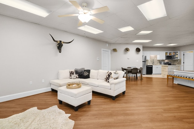 270 Milford Trl, Talking Rock, GA 30175 - living area with light wood finished floors, a drop ceiling, baseboards, and ceiling fan